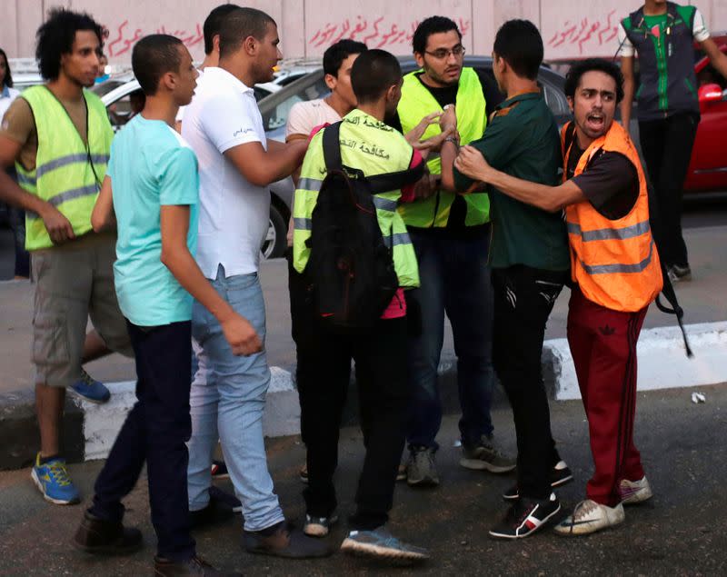 FILE PHOTO: Volunteers from anti-harassment group called "Harassing the Harasser" detain young man, after girl claimed that he was sexually harassing her, during Eid al-Fitr celebrations in central Cairo