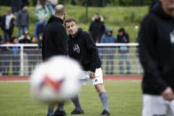 French President Emmanuel Macron participates in the Varietes Club charity football match to benefit children in hospital, at the Bernard Giroux stadium in Plaisir, outside Paris, Wednesday, April 24, 2024. (Benoit Tessier/Pool via AP)