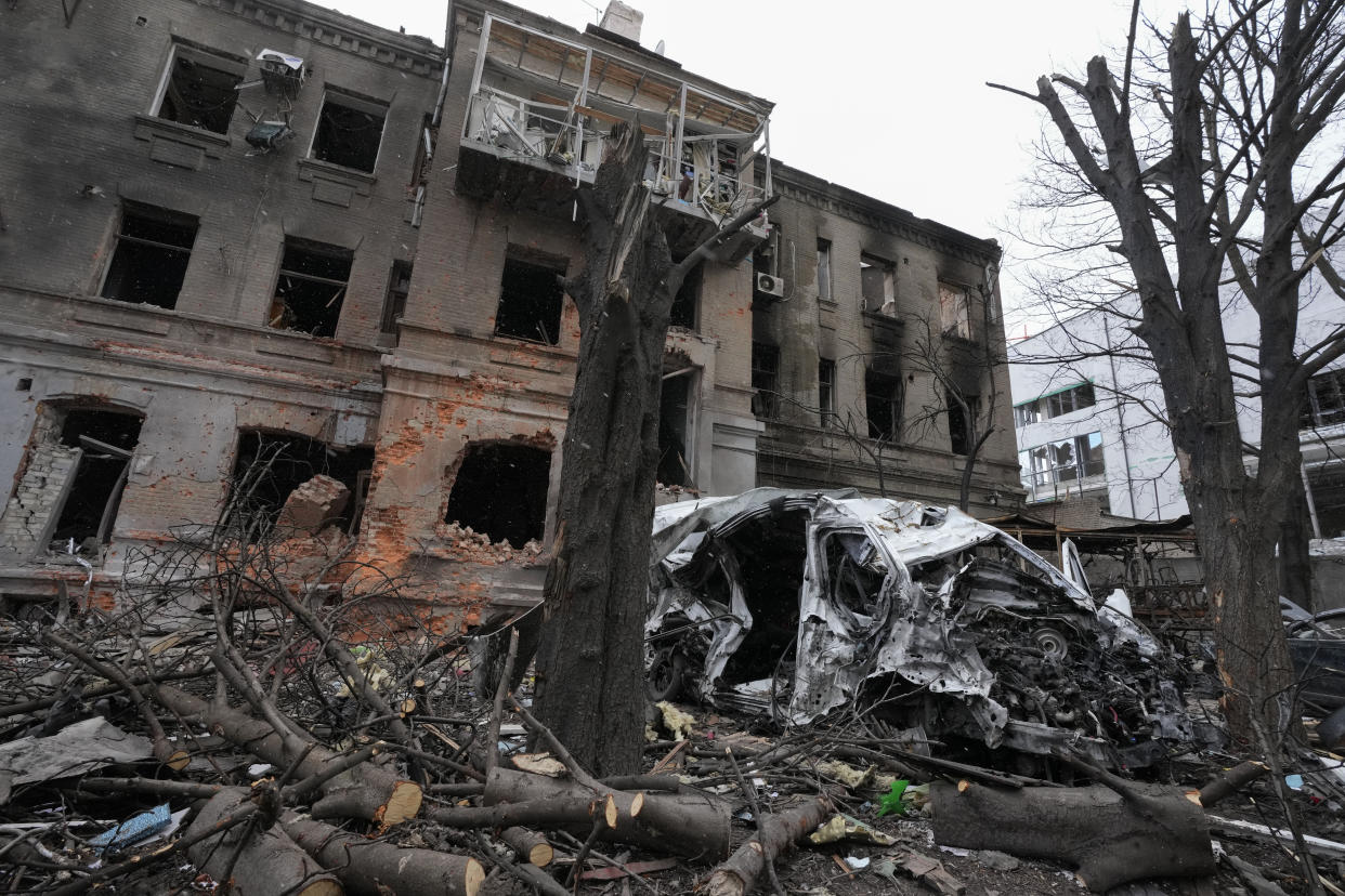 A damaged building and car after recent shelling, in the center of Kharkiv, Ukraine, Sunday, March 27, 2022. (AP Photo/Efrem Lukatsky)