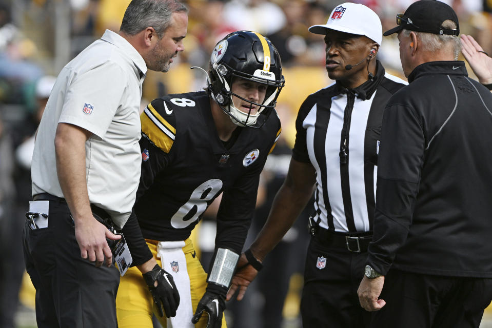 Pittsburgh Steelers quarterback Kenny Pickett (8) is helped on the field after being injured during the second half of an NFL football game against the Tampa Bay Buccaneers in Pittsburgh, Sunday, Oct. 16, 2022. (AP Photo/Barry Reeger)