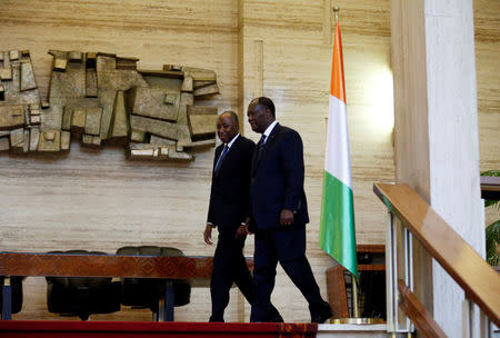 Ivory Coast President Alassane Ouattara (R) walks with the new Prime Minister Amadou Gon Coulibaly in the Presidential Palace in Abidjan, Ivory Coast January 10, 2017. REUTERS/Thierry Gouegnon