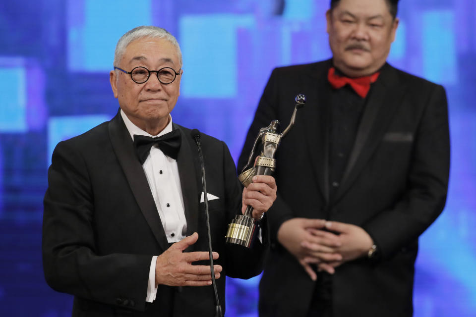 FILE - Hong Kong actor Kenneth Tsang poses after winning the Best Supporting Actor award for his movie "Overhead 3" during the Hong Kong Film Awards in Hong Kong Sunday, April 19, 2015. Hong Kong media reported that Tsang was found dead Wednesday in his quarantine hotel room after arriving from Singapore. (AP Photo/Vincent Yu, File)