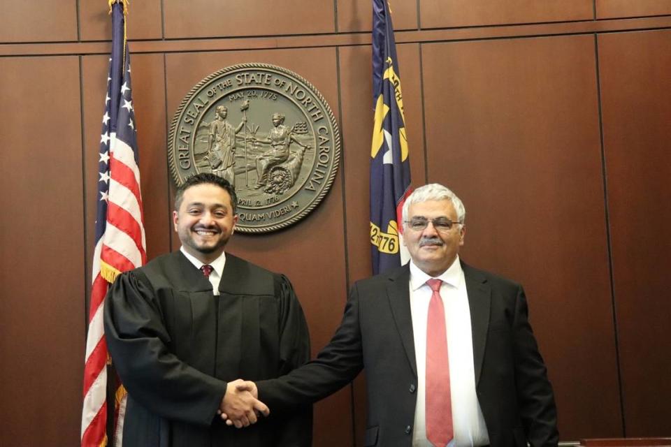 District Court Judge Rashad Hauter poses with his father, Ahmed, who brought him to the US from Yemen at age 3. Hauter is the country’s first Yemeni-born judge.