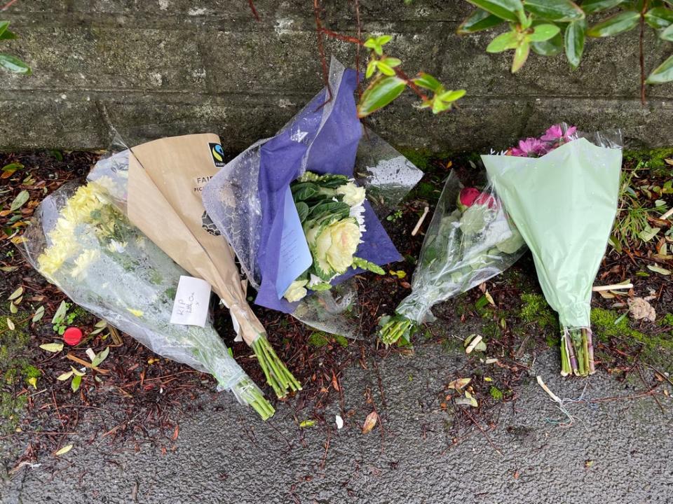 Flowers left outside the house in Pentwyn, Penyrheol, near Caerphilly where Jack Lis a 10-year-old boy was killed by a dog (PA)