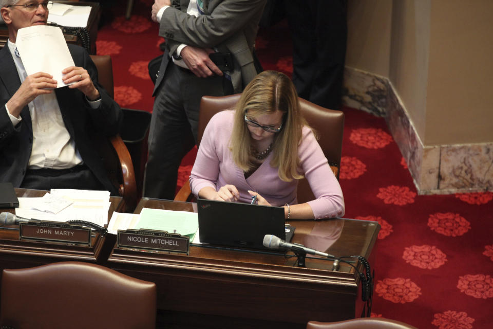 Minnesota state Sen. Nicole Mitchell, a Democrat from Woodbury who faces an ethics hearing Tuesday stemming from her arrest on a felony burglary charge, is shown seated at her desk on the Senate floor in the State Capitol in St. Paul, on Monday, May 6, 2024. Mitchell told police she broke in last month because her stepmother refused to give her items of sentimental value from her late father. (AP Photo/Steve Karnowski)