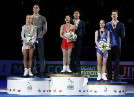 Figure Skating - ISU World Championships 2017 - Pairs Victory Ceremony - Helsinki, Finland - 30/3/17 - Gold medallists Sui Wenjing and Han Cong of China (C), silver medallists Aliona Savchenko and Bruno Massot of Germany (L) and bronze medallists Evgenia Tarasova and Vladimir Morozov of Russia attend the ceremony. REUTERS/Grigory Dukor