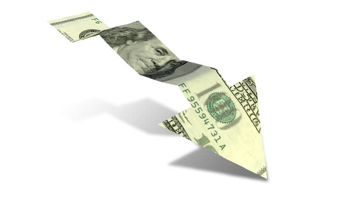 Cut-out of $100 bill forming an arrow trending downward