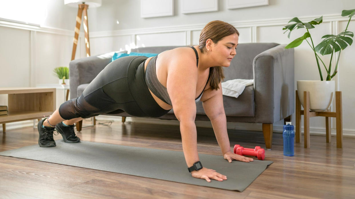  Woman holding a plank position. 