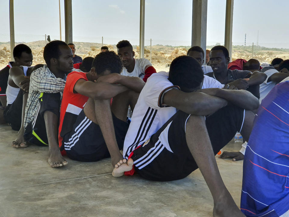 Rescued migrants rest near the city of Khoms, around 120 kilometers (75 miles) east of Tripoli, Libya., Tuesday, Aug. 27, 2019. At least 65 migrants, mostly from Sudan, were rescued, said a spokesman for Libya's coast guard, with a search halted for those still missing. The coast guard gave an estimate for those missing and feared drowned of 15 to 20 people.(AP Photo/Hazem Ahmed)