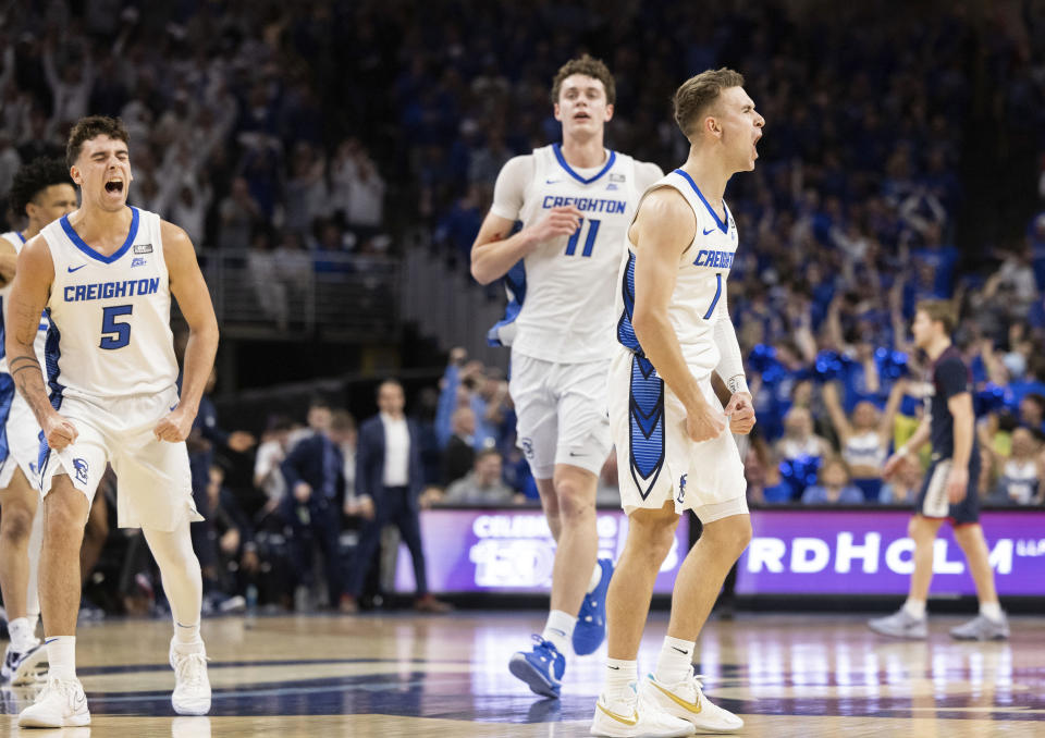 Creighton's Steven Ashworth (1) celebrates after making a 3-point shot against UConn, alongside teammates Francisco Farabello (5) and Ryan Kalkbrenner (11) during the first half of an NCAA college basketball game Tuesday, Feb. 20, 2024, in Omaha, Neb. (AP Photo/Rebecca S. Gratz)