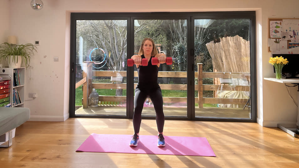 Maddy Biddulph performing a lateral arm raise squat