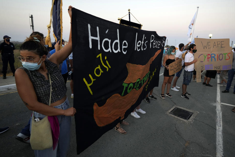 FILE - In this Monday, July 19, 2021 file photo, protesters hold a banner during a rally against the Turkish President visiting the Turkish occupied part of the island, in Dherynia, Cyprus. Nikos Christodoulides, the foreign minister of the divided island of Cyprus is accusing Turkey's president of attempting to promote a new Ottoman empire in the eastern Mediterranean and the Middle East — and says such an approach to geopolitics could adversely impact regional security. Christodoulides was interviewed Monday, Sept. 27, the final day of the U.N. General Assembly’s annual high-level gathering of world leaders. (AP Photo/Petros Karadjias, File)