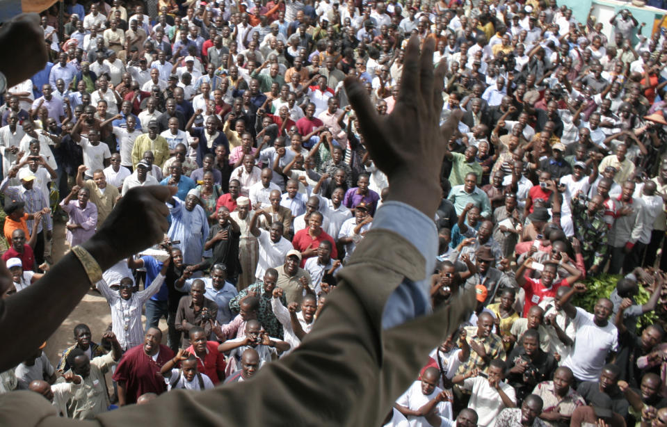 People chant in protest against the recent military coup, in Bamako, Mali, Monday, March 26, 2012. About a thousand demonstrators gathered Monday in Mali's capital to demand a return to constitutional order days after mutinous soldiers claimed to have power in a coup.(AP Photo/Harouna Traore)