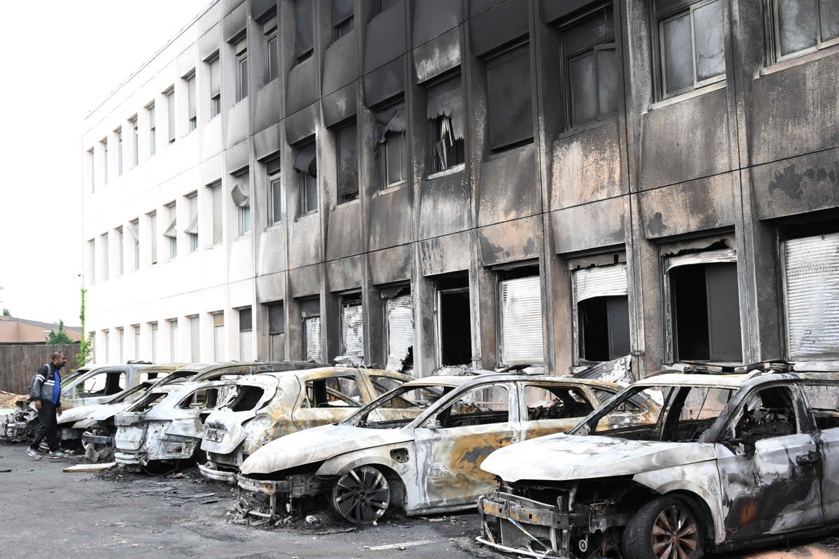 Seven burnt out vehicles are seen outside the municipal police building following violence in Neuilly-sur-Marne on 29 June 2023 (AFP via Getty Images)