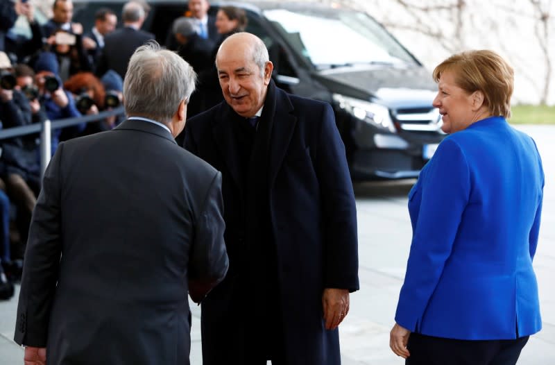 German Chancellor Angela Merkel and United Nations Secretary-General Antonio Guterres welcome Algerian President Abdelmadjid Tebboune at the Libya summit in Berlin