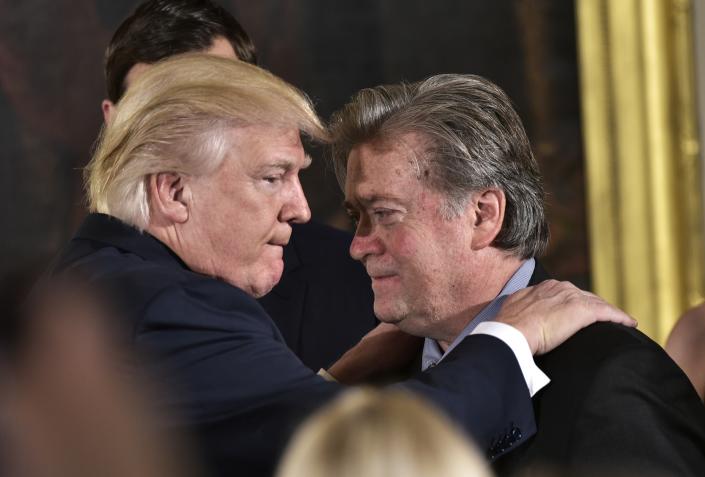 President Donald Trump congratulates then-Senior Counselor to the President Stephen Bannon during the swearing-in of senior staff in the East Room of the White House on January 22, 2017 in Washington, DC. (Mandel Ngan/AFP via Getty Images)