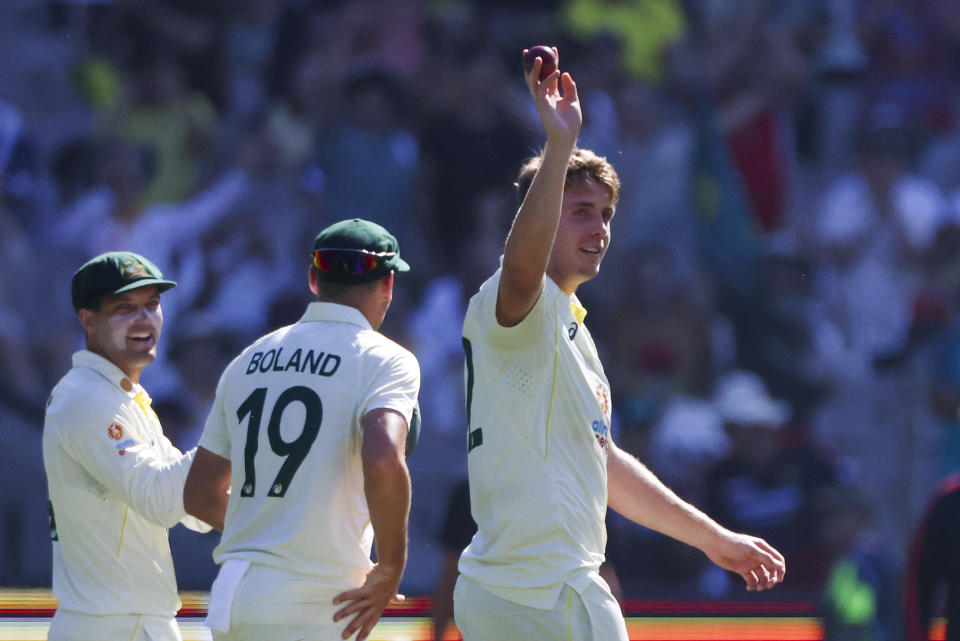 Australia's Cameron Green, right, gestures to the crowd after taking five wickets during the second cricket test between South Africa and Australia at the Melbourne Cricket Ground, Australia, Monday, Dec. 26, 2022. (AP Photo/Asanka Brendon Ratnayake)