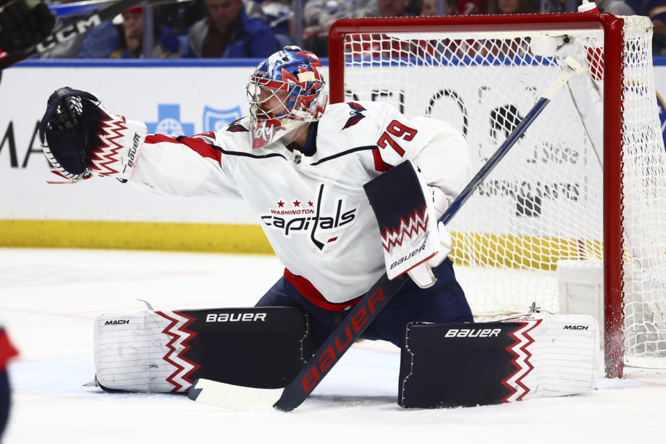 Washington Capitals goaltender Charlie Lindgren (79) reaches for the puck during the first period of an NHL hockey game against the Buffalo Sabres Tuesday, April 2, 2024, in Buffalo, N.Y. (AP Photo/Jeffrey T. Barnes)