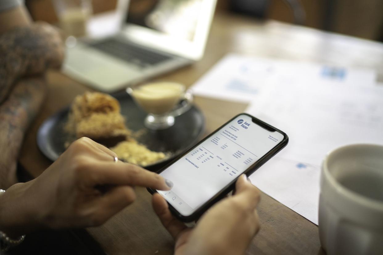 woman checking account statement of her digital investment on her mobile phone