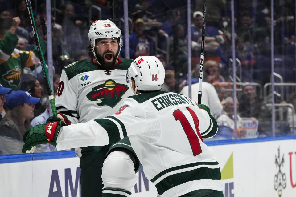 Minnesota Wild's Pat Maroon (20) celebrates with teammate Joel Eriksson Ek (14) after scoring a goal during the first period of an NHL hockey game against the New York Islanders Tuesday, Nov. 7, 2023, in Elmont, N.Y. (AP Photo/Frank Franklin II)