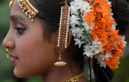 Detail of jewellery and floral display is seen on a woman promoting a stand at the RHS Chelsea Flower Show in London, Britain, May 21, 2018. REUTERS/Toby Melville