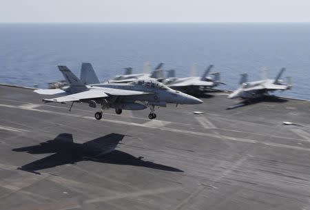 A F/A-18E/F Super Hornets of Strike Fighter Attack Squadron 211 (VFA-211) lands on the flight deck of the USS Theodore Roosevelt (CVN-71) aircraft carrier in the Gulf June 18, 2015. REUTERS/Hamad I Mohammed