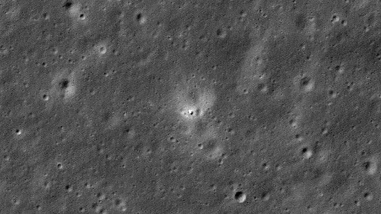  A chinese spacecraft is seen as a small white spot on the moon's gray, cratered far side. 