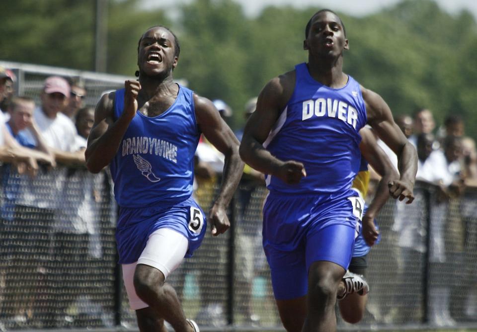 Creighton Walker (right) of Dover goes neck and neck with Gerald Backus of Brandywine in the boys 200 meter dash Division 1 Saturday, May 22, 2004.