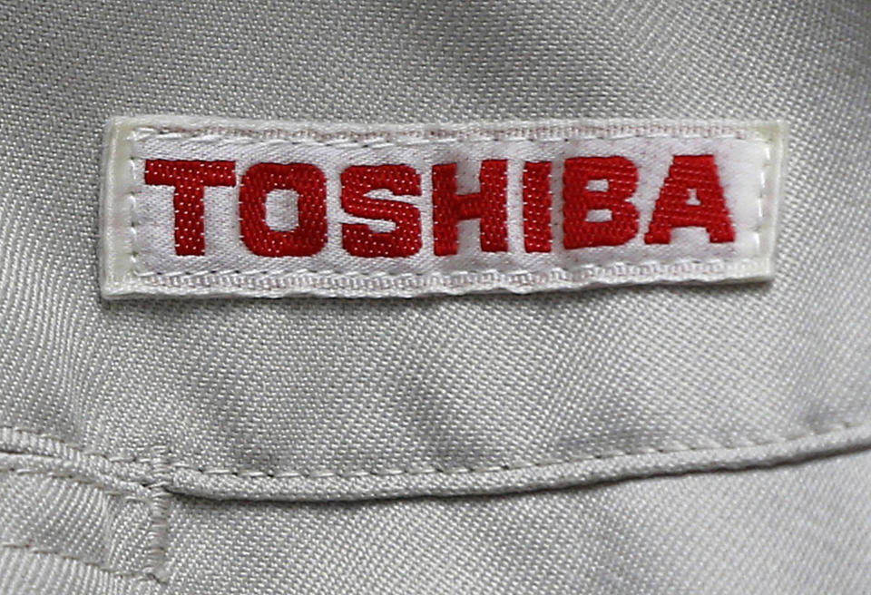 FILE - In this Thursday, June 15, 2017, photo, the logo of Toshiba Corp., Japan's electronics and energy company, is seen on a worker's jacket in Yokosuka, near Tokyo. Toshiba Corp. has brushed off a new missive from CVC Partners about the global fund's interest in acquiring the Japanese manufacturer. Toshiba said Tuesday that a letter from CVC was “not possible to evaluate.” (AP Photo/Shuji Kajiyama, File)