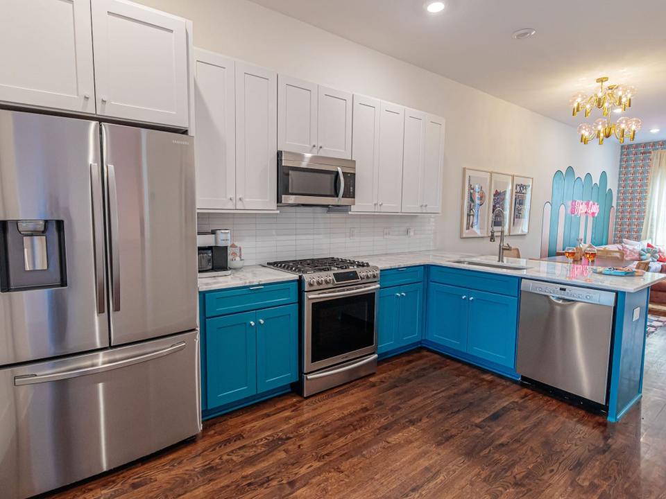 A kitchen with blue cabinetry.