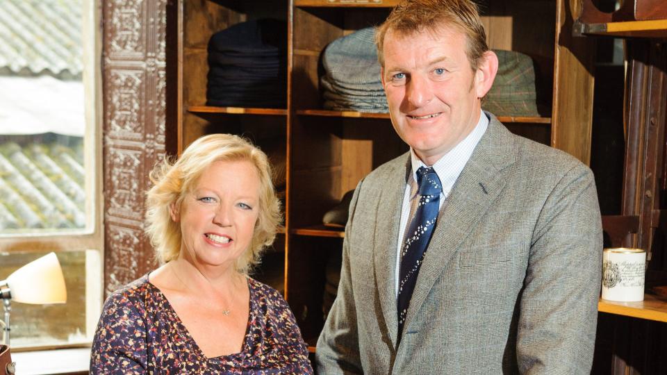 Deborah Meaden in a floral dress with her husband Paul 