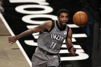 Brooklyn Nets guard Kyrie Irving chases down the ball during the second half of an NBA basketball game against the Miami Heat, Monday, Jan. 25, 2021, in New York. (AP Photo/Adam Hunger)