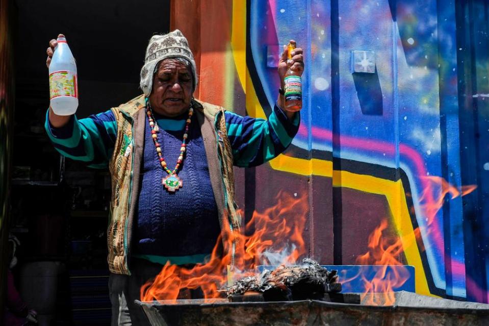 An Aymara priest, or yatiri, performs an Andean ritual to thank the Pachamama (Mother Earth) in El Alto, on 1 December 2019.