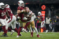 Arizona Cardinals quarterback Colt McCoy is sacked by San Francisco 49ers defensive tackle Kevin Givens during the second half of an NFL football game Monday, Nov. 21, 2022, in Mexico City. (AP Photo/Eduardo Verdugo)