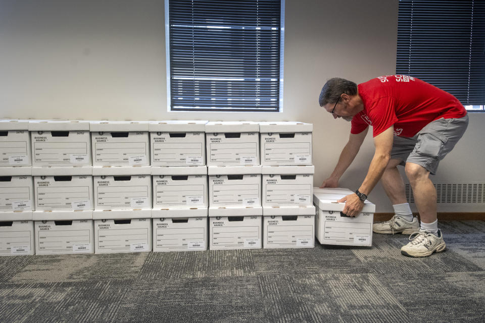 FILE - John Heineman delivers a box of petition signatures from Support Our Schools Nebraska to the Nebraska Secretary of State, Aug. 30, 2023, in Lincoln, Neb. Nebraska lawmakers are on track to pass a bill that would circumvent Nebraska voters who could repeal a new Nebraska law that funds private school tuition with taxpayer money. The bill by Omaha Sen. Lou Ann Linehan advanced Tuesday from the first of three rounds of debate. (Justin Wan/Lincoln Journal Star via AP, File)