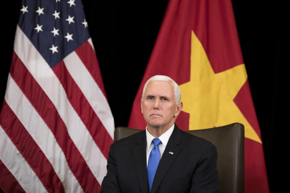 U.S. Vice President Mike Pence listens to Vietnam's Prime Minister Nguyen Xuan Phuc, not seen, in Singapore, Wednesday, Nov. 14, 2018. Pence is Singapore to attend the 33rd ASEAN summit. (AP Photo/Bernat Armangue, Pool)