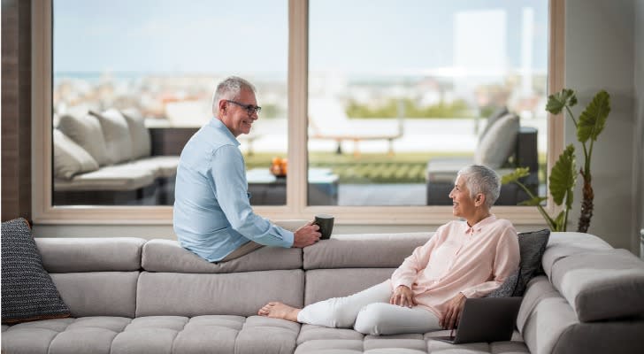 A retired couple relaxes in their penthouse apartment. 