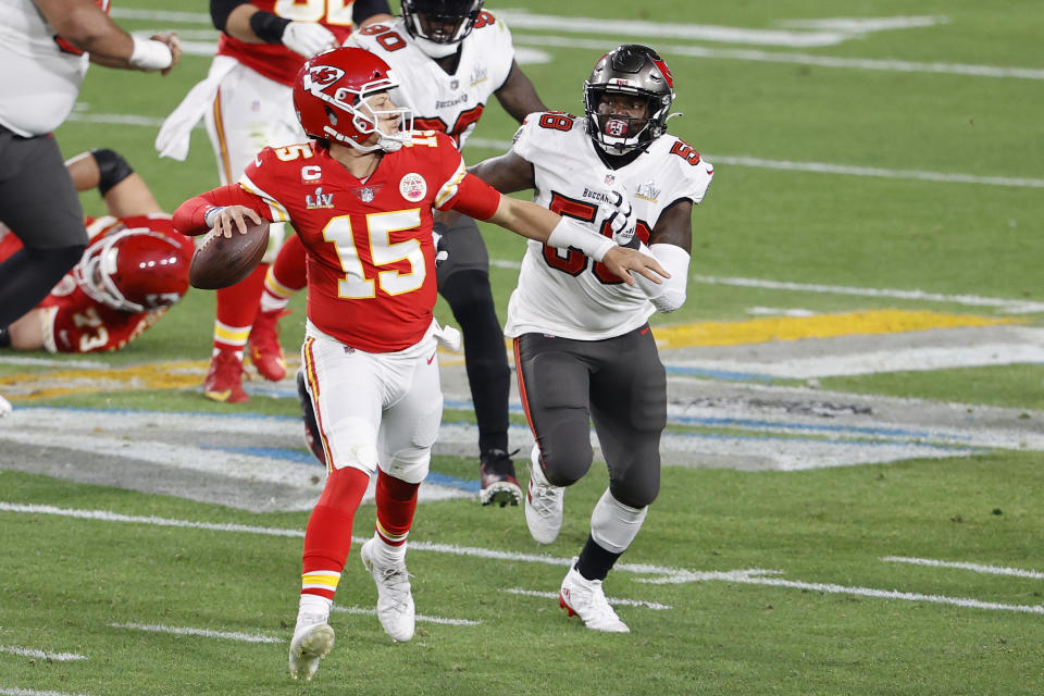 Feb 7, 2020; Tampa, FL, USA; Kansas City Chiefs quarterback Patrick Mahomes (15) rolls out to pass against Tampa Bay Buccaneers outside linebacker Shaquil Barrett (58) during the second quarter of Super Bowl LV at Raymond James Stadium.  Mandatory Credit: Kim Klement-USA TODAY Sports