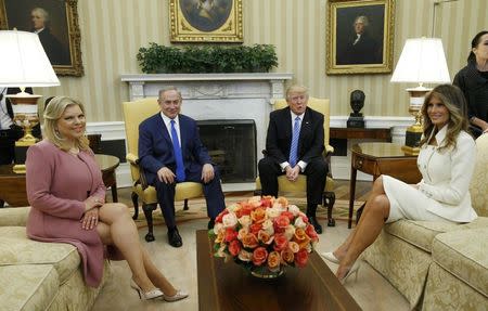 U.S. President Donald Trump (2ndR) and first lady Melania Trump meet Israeli Prime Minister Benjamin Netanyahu and his wife Sara (L) in the Oval Office of White House in Washington, U.S., February 15, 2017. REUTERS/Kevin Lamarque