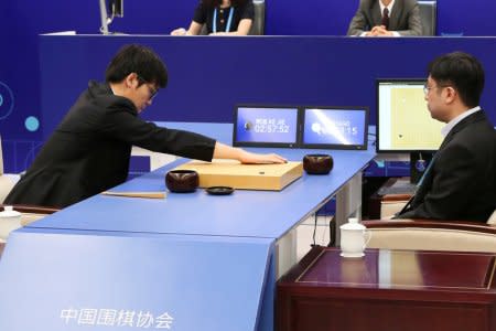 Chinese Go player Ke Jie puts a stone against Google's artificial intelligence program AlphaGo during their first match at the Future of Go Summit in Wuzhen, Zhejiang province, China May 23, 2017. REUTERS/Stringer