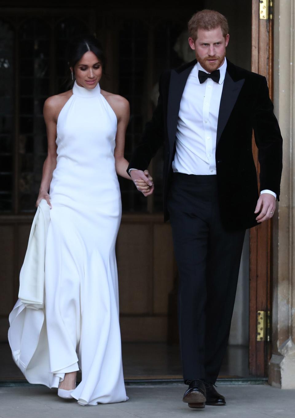 Duchess of Sussex and Prince Harry, Duke of Sussex leave Windsor Castle after their wedding to attend an evening reception at Frogmore House, hosted by the Prince of Wales on May 19, 2018 in Windsor, England