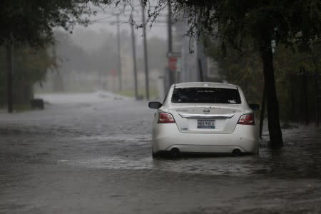 A car is surrounded by flood waters on Aiken Street during Hurricane Dorian in Charleston