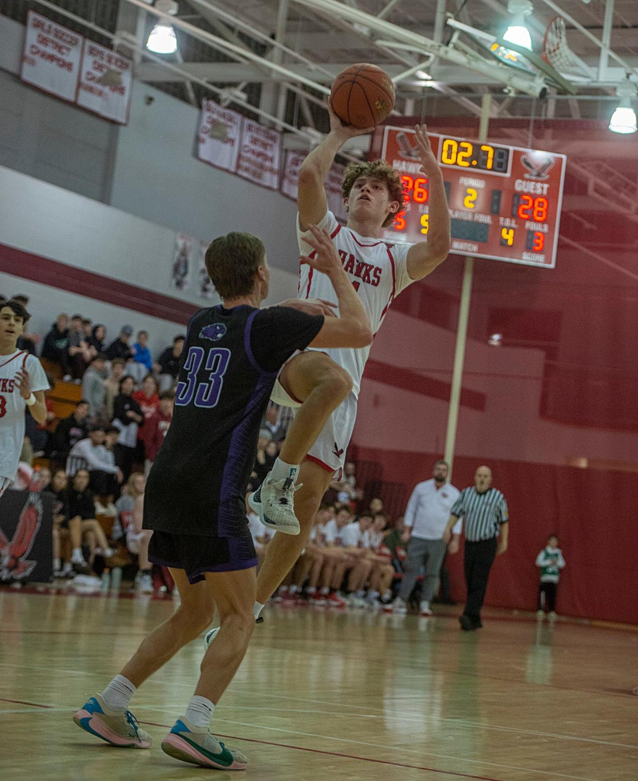 Hudson High School junior captain Jake Attaway looks to shoot against Blackstone Valley Tech in a first round state tournament playoff game, Feb. 27, 2024.