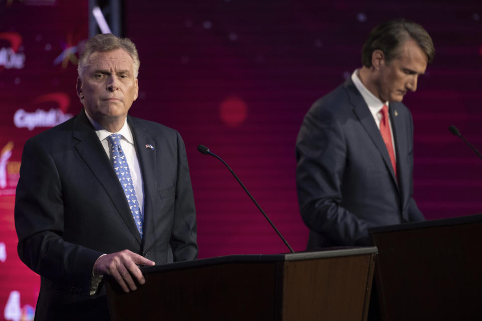 Virginia Democratic gubernatorial candidate and former Gov. Terry McAuliffe, left, and Republican challenger, Glenn Youngkin, participate in a debate at Northern Virginia Community College, in Alexandria, Va., Tuesday, Sept. 28, 2021. (AP Photo/Cliff Owen)