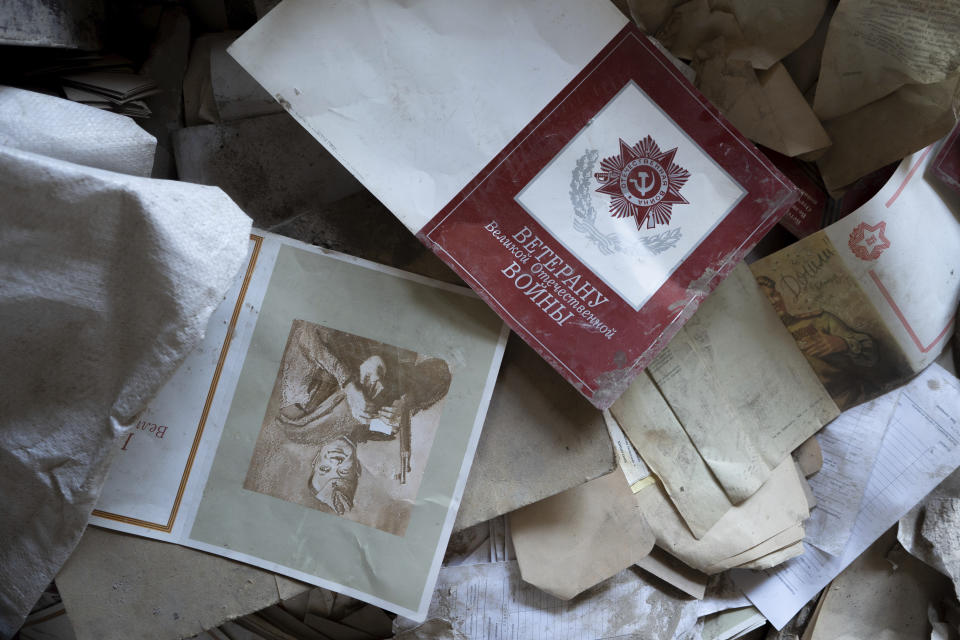 This photo shows an old book printed during Ukraine's Soviet era, damaged during a Russian air assault on a manufacturing plant where visually impaired people used to work, in Kyiv, Ukraine, on May 30, 2023. Losing the place of work is just one of a multitude of challenges that people with visual impairments face across Ukraine since Russia launched a full-scale invasion in February 2022. (AP Photo/Roman Hrytsyna)