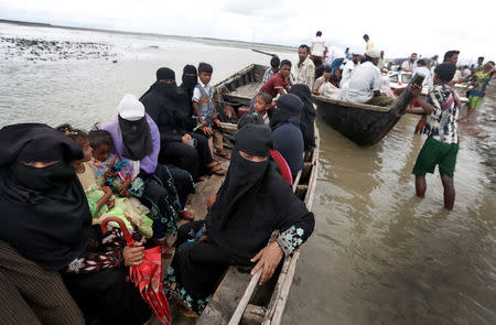 Rohingya refugees wait to be transported to Cox's Bazar after their arrival, Bangladesh September 18, 2017. REUTERS/Cathal McNaughton