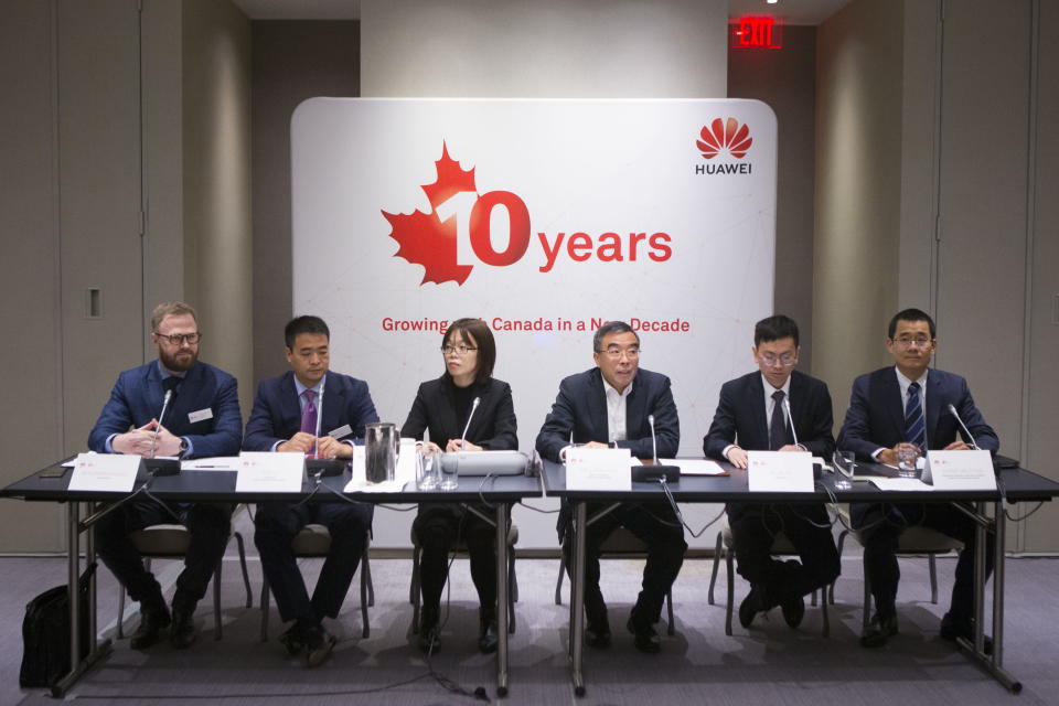 Liang Hua (centre), Chairman of Huawei’s Board of Directors, sits with Eric Li (second left), President of Huawei Technologies Canada and Mr Christian Chua (far right) President of R & D Huawei Technologies Canada, as they attend a media roundtable event in Toronto, on Thursday, February 21, 2019. (THE CANADIAN PRESS/Chris Young)