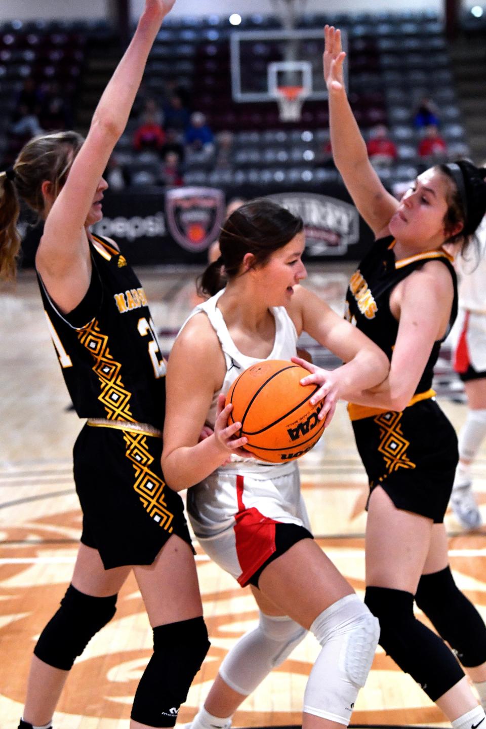 Jim Ned's Kate Bryant, one of two seniors on the team, looks to pass the ball as Seminole's Tatum Medlin (left) and Londyn Shain defend during the championship game of the Pug Parris Classic Nov. 19 at McMurry's Kimbrell Arena.