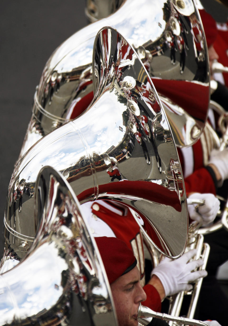 Other Wisconsin band members are reflected in the tuba section as the band marches in the 124th Rose Parade in Pasadena, Calif., Tuesday, Jan. 1, 2013. Wisconsin will play Stanford in the Rose Bowl football game. (AP Photo/Reed Saxon)