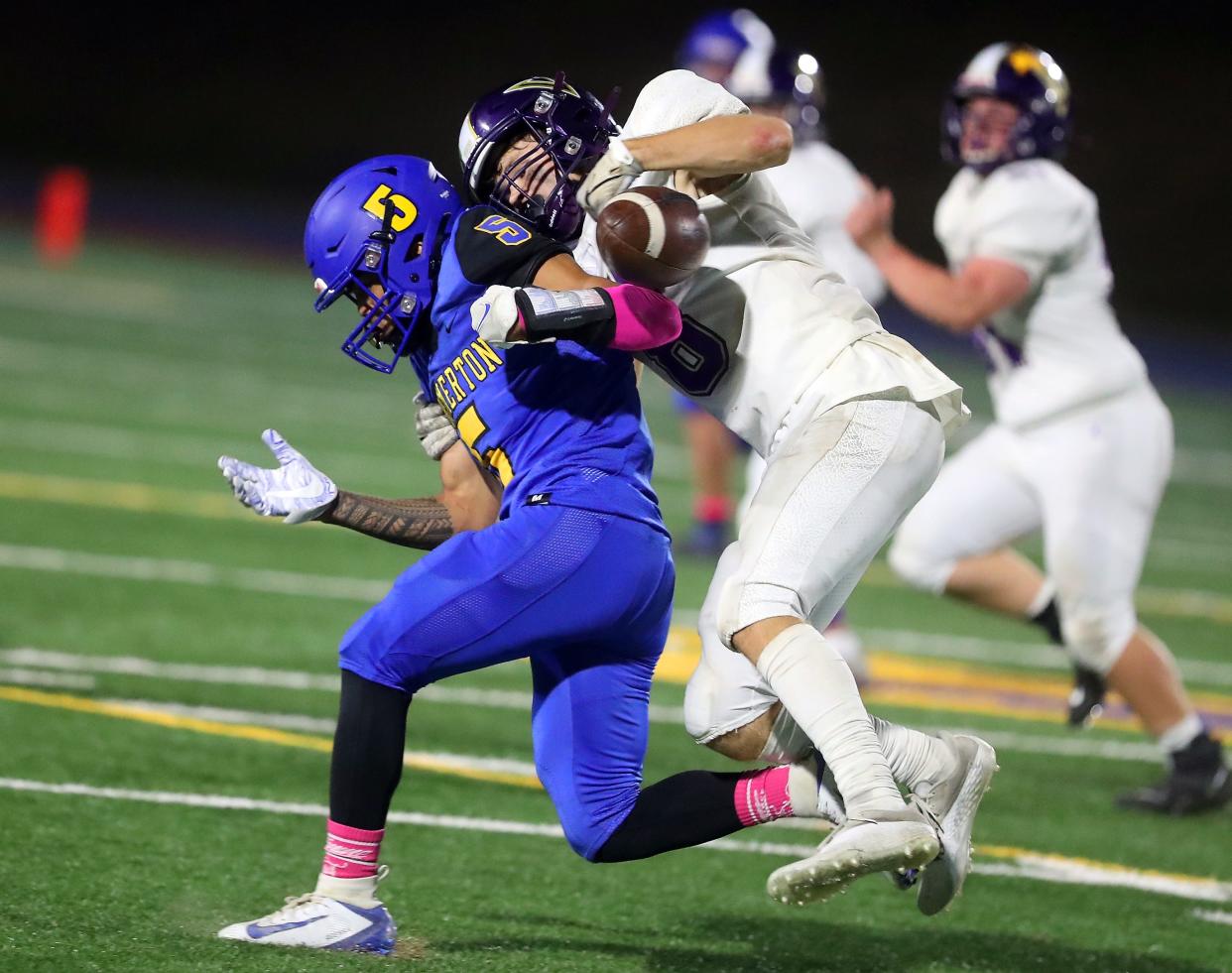 North Kitsap's Logan Sloman (8) strips the ball from Bremerton's Jayden Quenga (5) while tackling him during their game at Bremerton Memorial Stadium on Friday, Oct. 14, 2022.